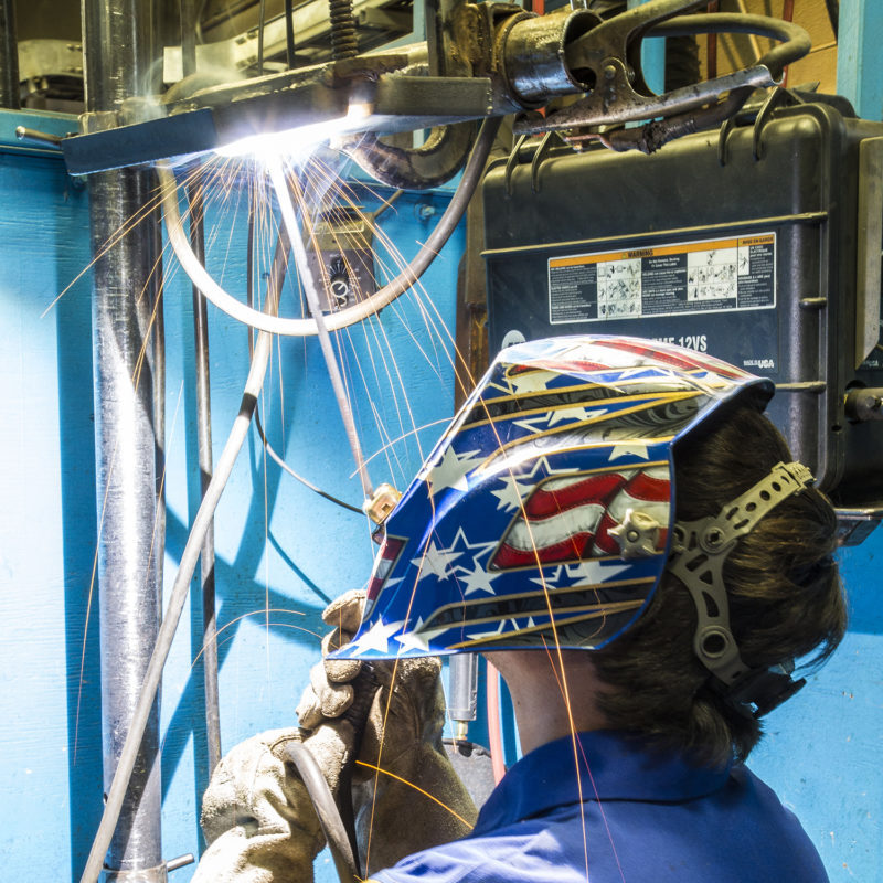 Sheridan College student welding.