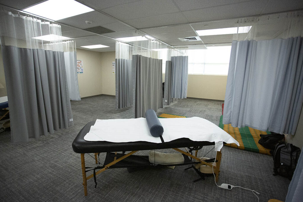 Massage Therapy Facility with bed and curtains showing three separate spaces