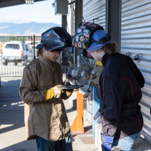Sheridan College Welding students check to see how their project is turning out.
