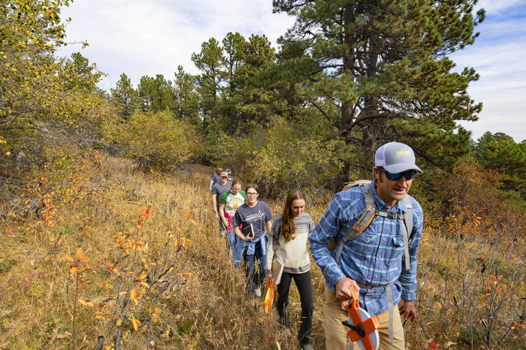 Scott newbold leadinga  biology class on a hike on the penrose trail near Sheridan