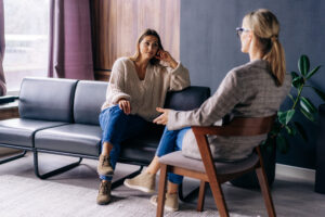 A young woman in a consultation with a professional psychologist listens to advice on improving behavior in life. The modern millennial woman is developing mindfulness and psychological health.