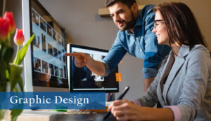 Two graphic designers, one male and one female, looking at a colorful computer screen with imagery.