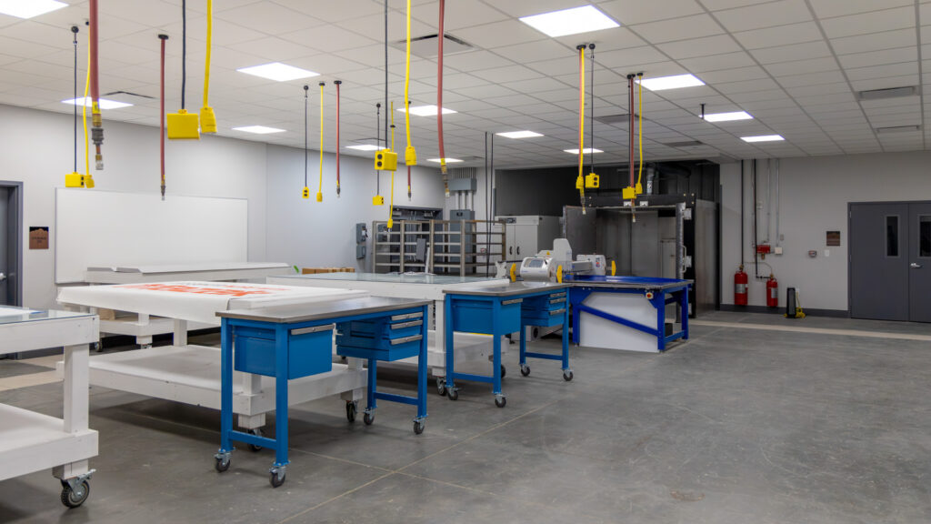 Room view with multiple Eastman Eagle tables and Despatch Laboratory Oven in the background.