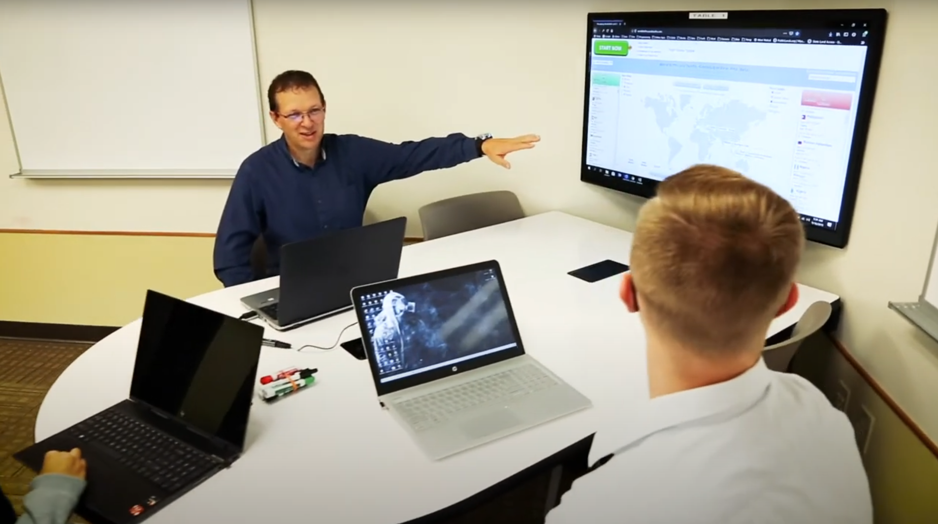 Professor Mark Thoney pointing at Computing Lesson with two students