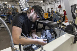 Student using traditional lathe in machine tool lab