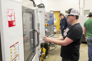 Machine tool student using one of the CNC machines at Sheridan College
