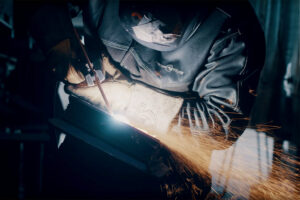 Sheridan College student welding.