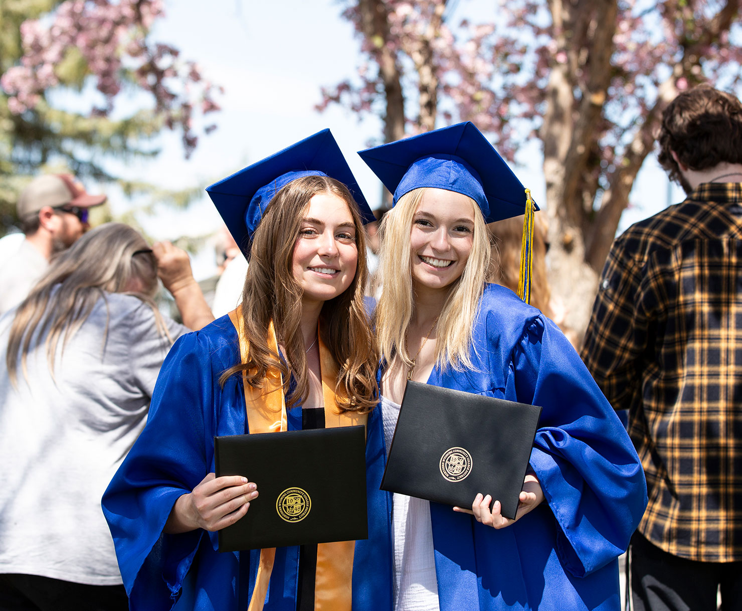 Sheridan College graduates celebrating after commencement ceremony.