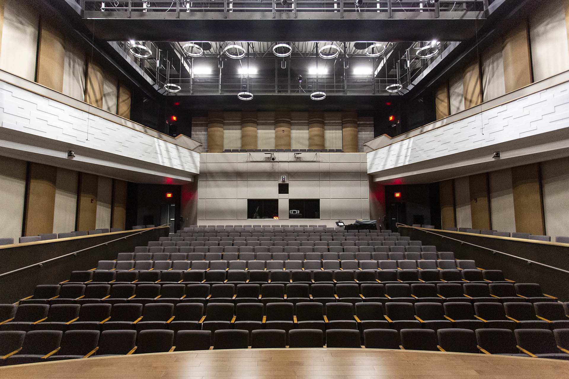 Looking back inside Kinnison Hall up at the lights and second floor and all the seats