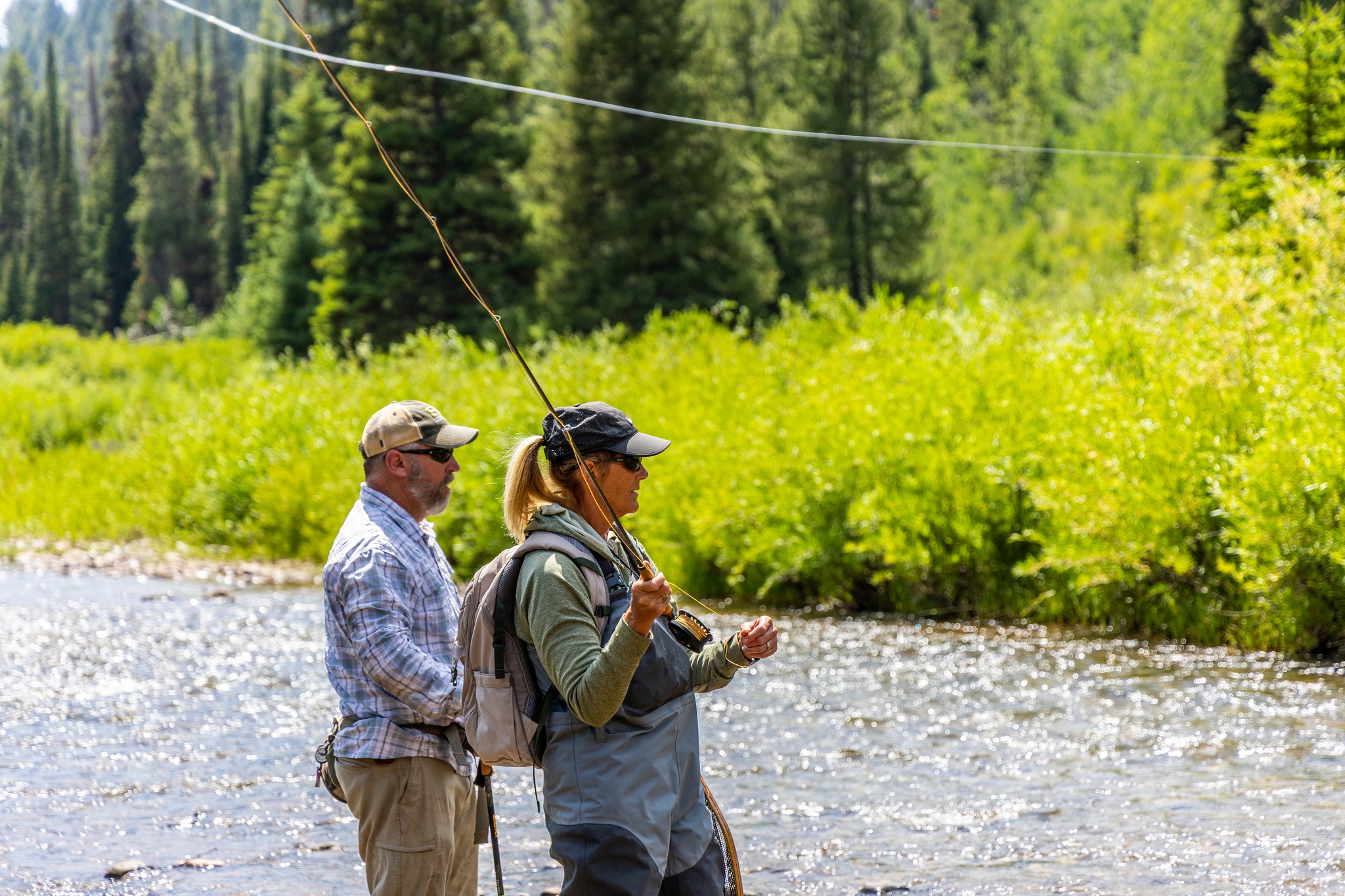 Photo of instructor and student fly fishing