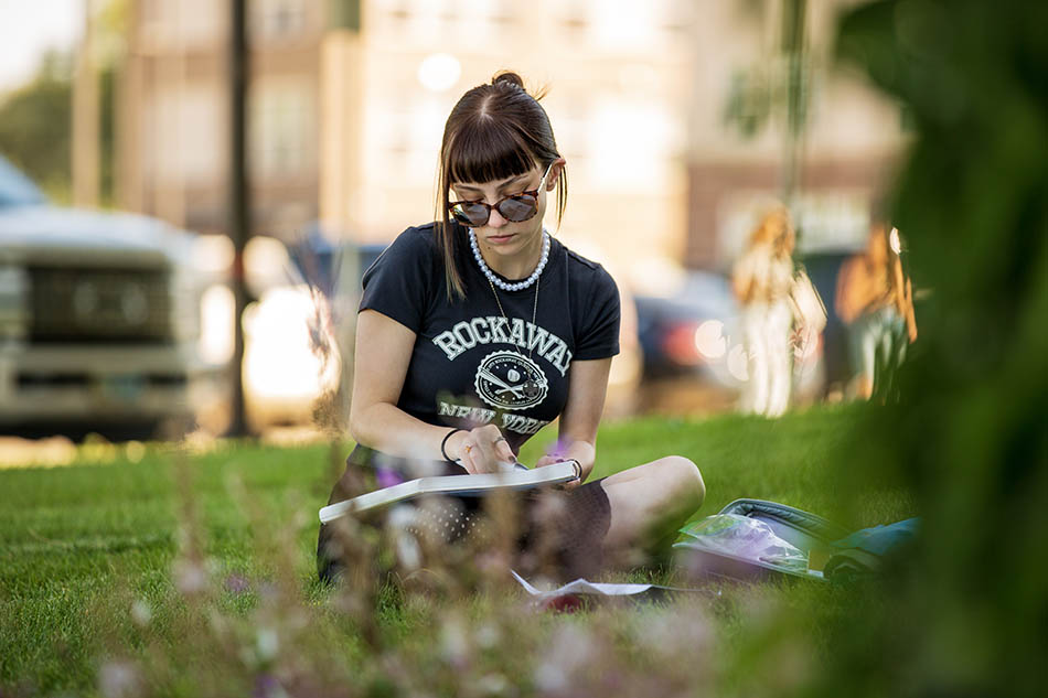 Student working on a drawing outside at Sheridan College
