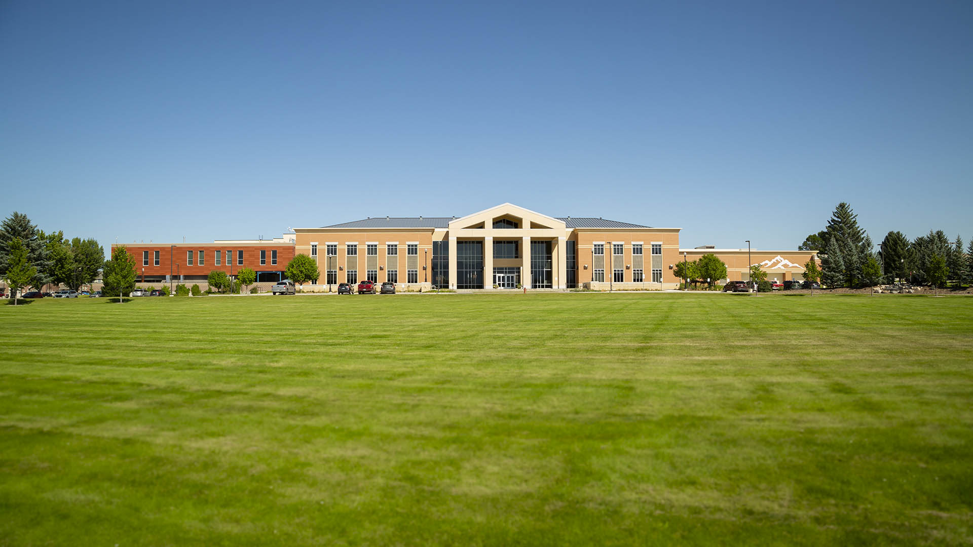 Image of the Whitney Academic Center and front lawn at Sheridan College