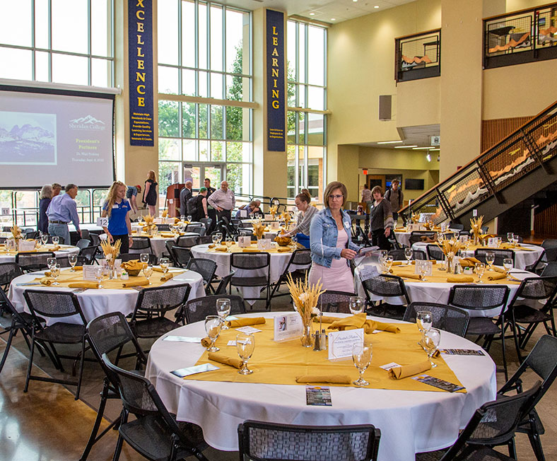Sheridan College conference and events photo of staff observing table setting.