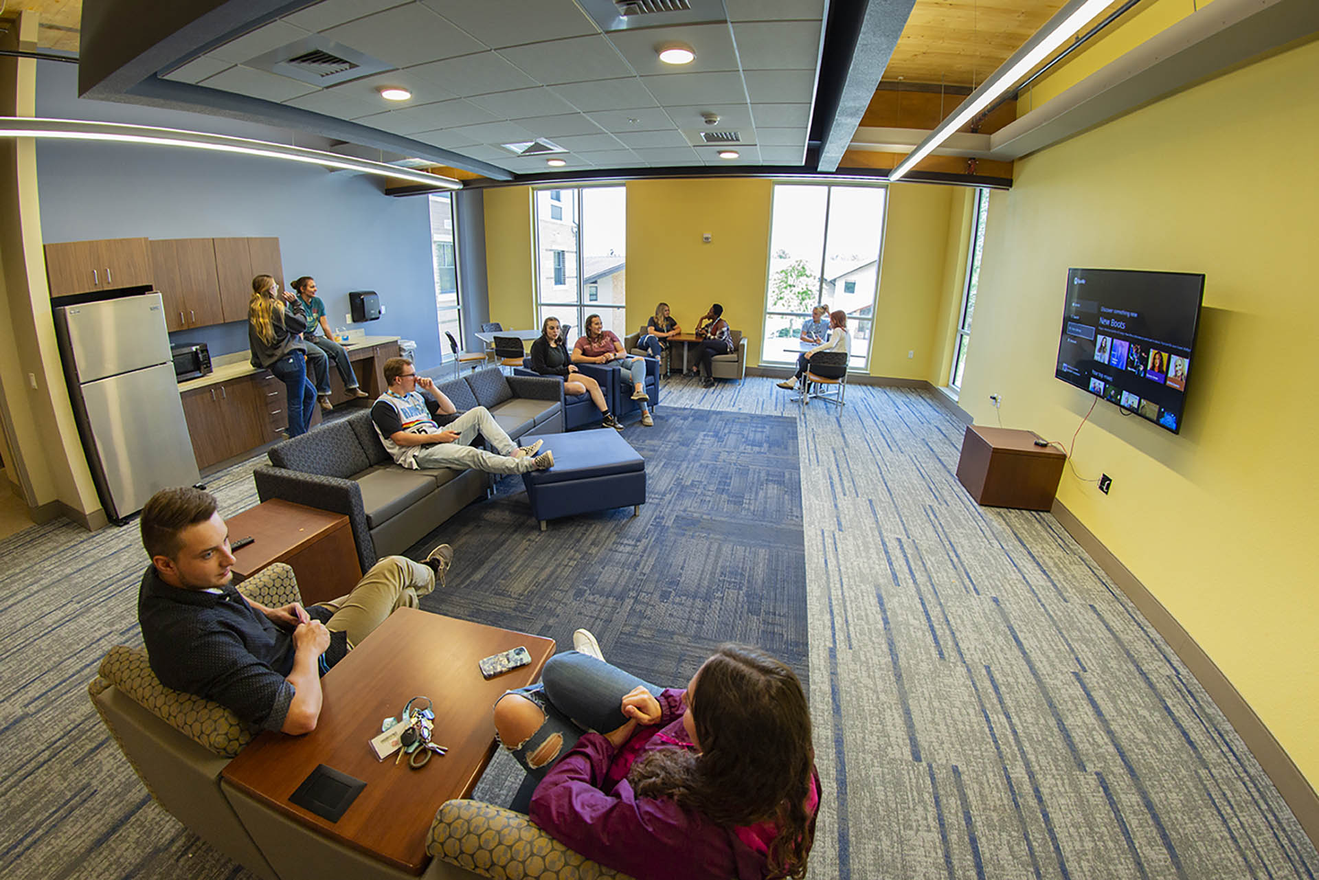 A group of students hanging out in the common area in Centennial Hall