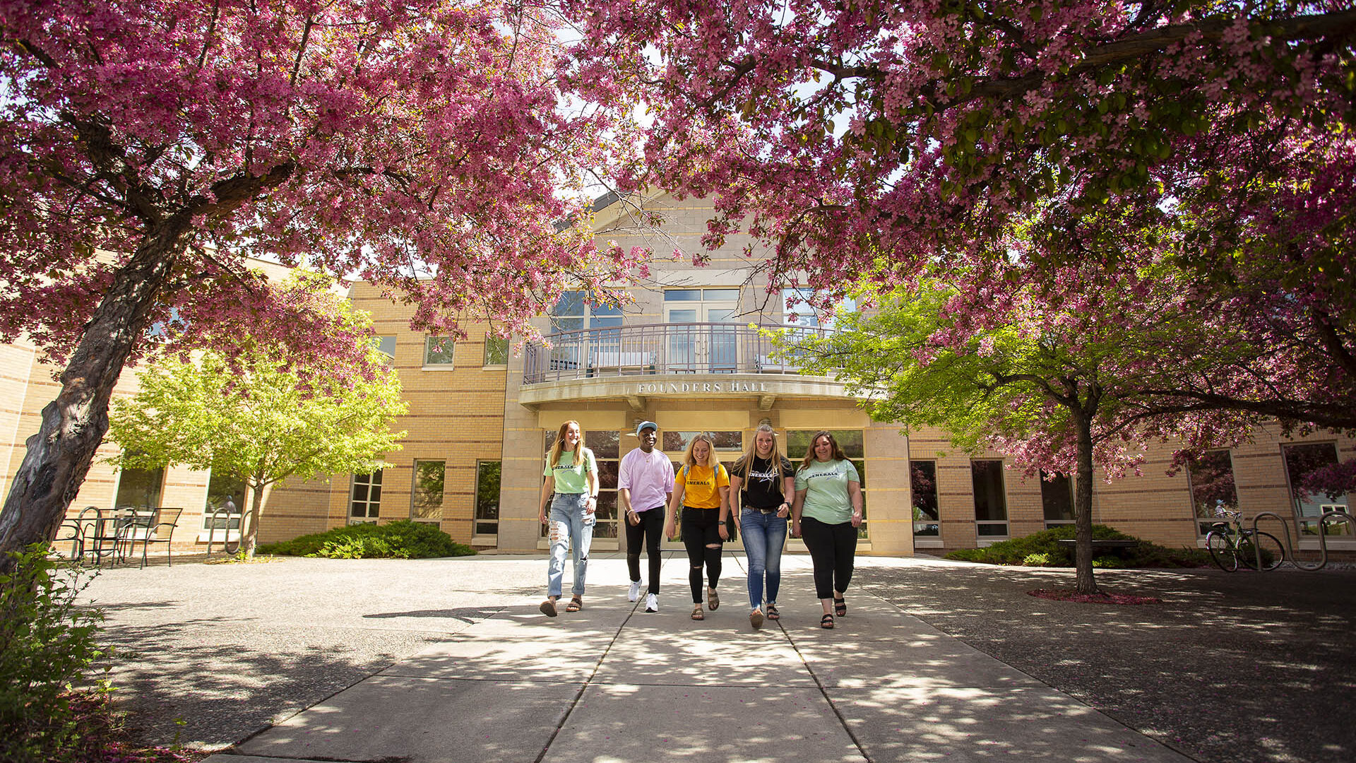 Sheridan College students walking outside the Founders Hall