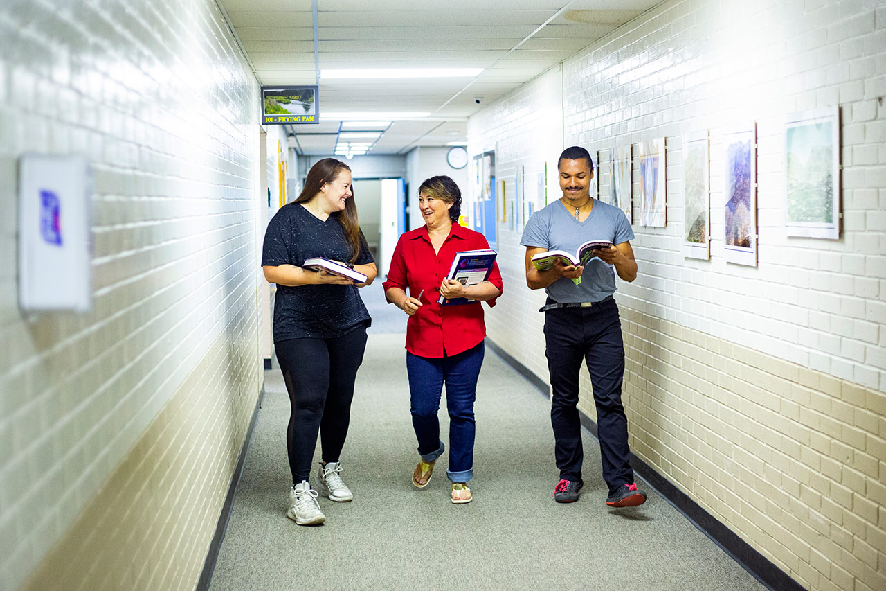 Sheridan College in Johnson County students walk in the hallway.