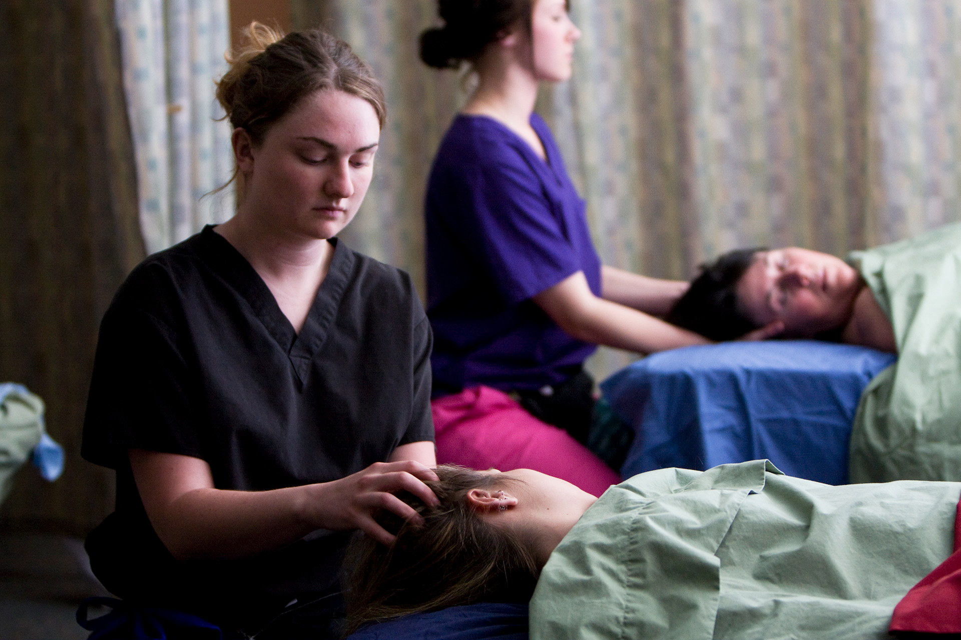 Massage Therapy students in class working with patients.