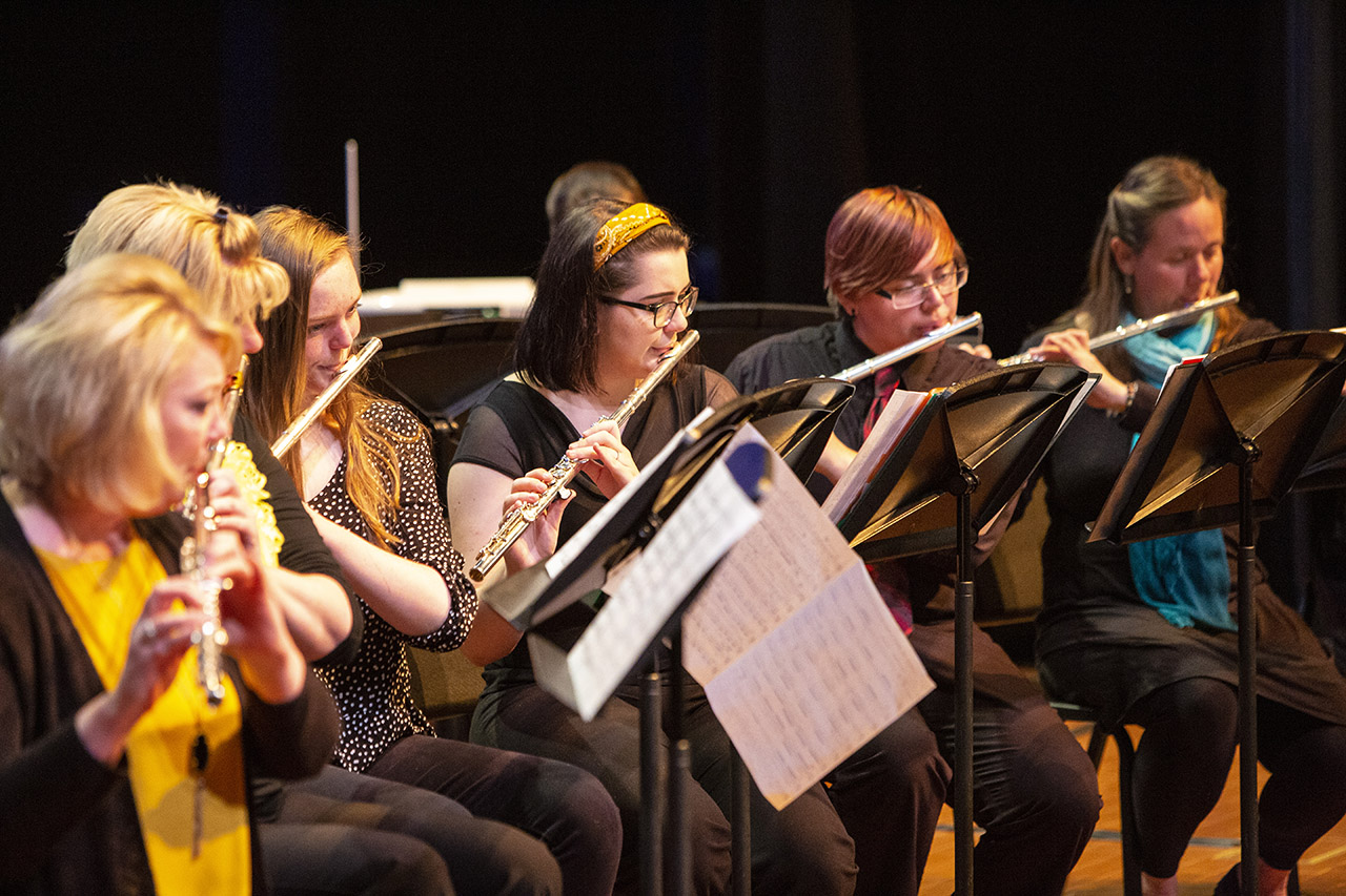 Several flautists performing on stage at sheridan college