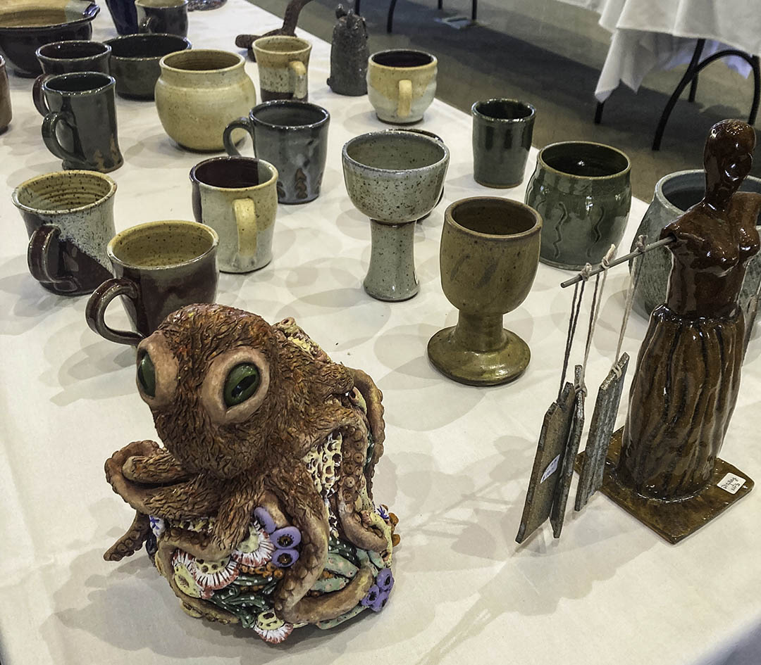 image showing a colorful sculpture of an octopus and some ceramic mugs
