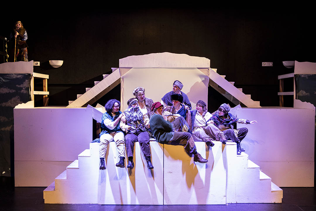 Sheridan College theater students on stage in purple light on the set of The Snow