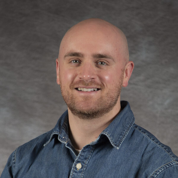 Headshot photo of Jacob Hirschman in a blue shirt