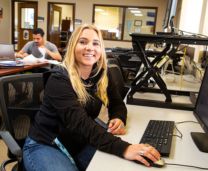 Sheridan College in TRIO classroom using a computer.