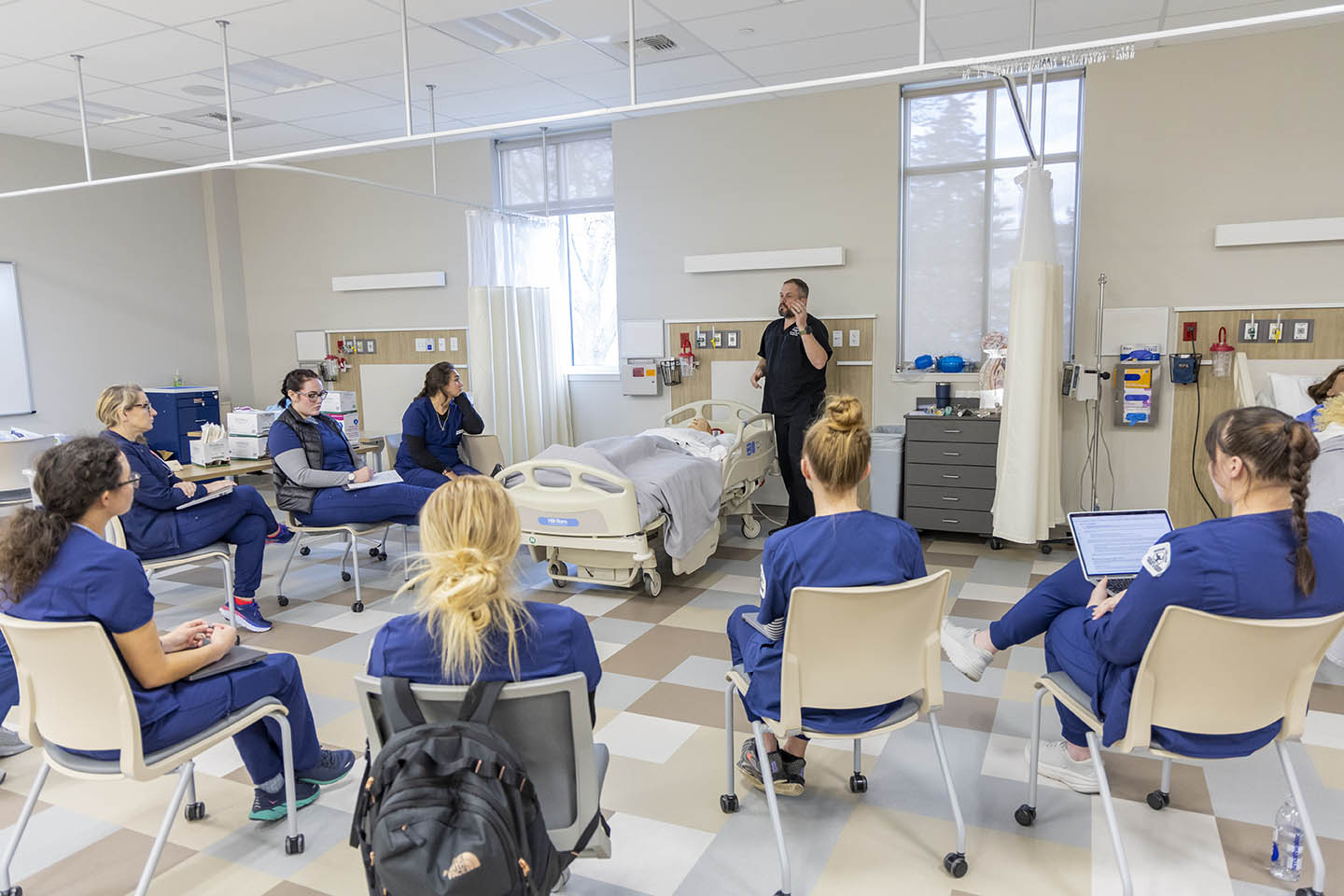 Nursing Classroom with students in chairs listening to the instructor