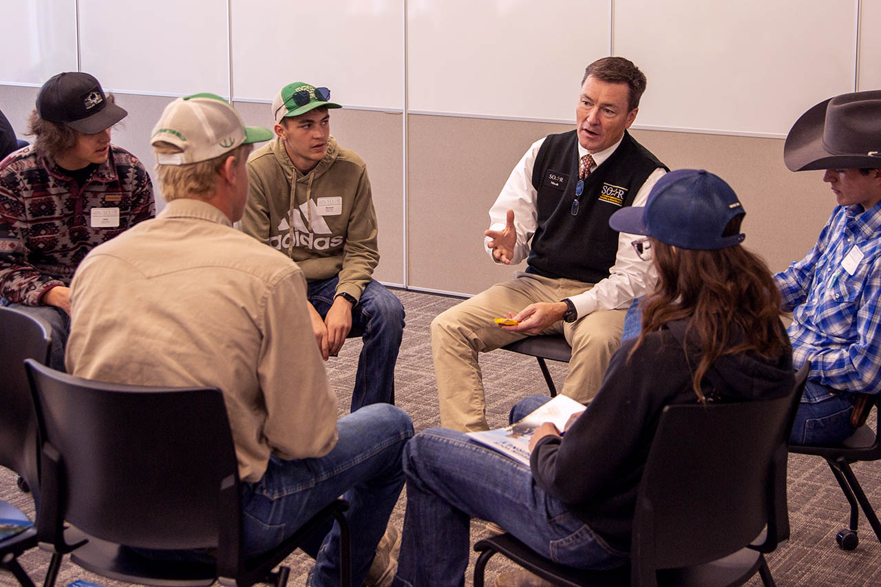 Image of Micah Olsen talking with incoming students during a SOAR event