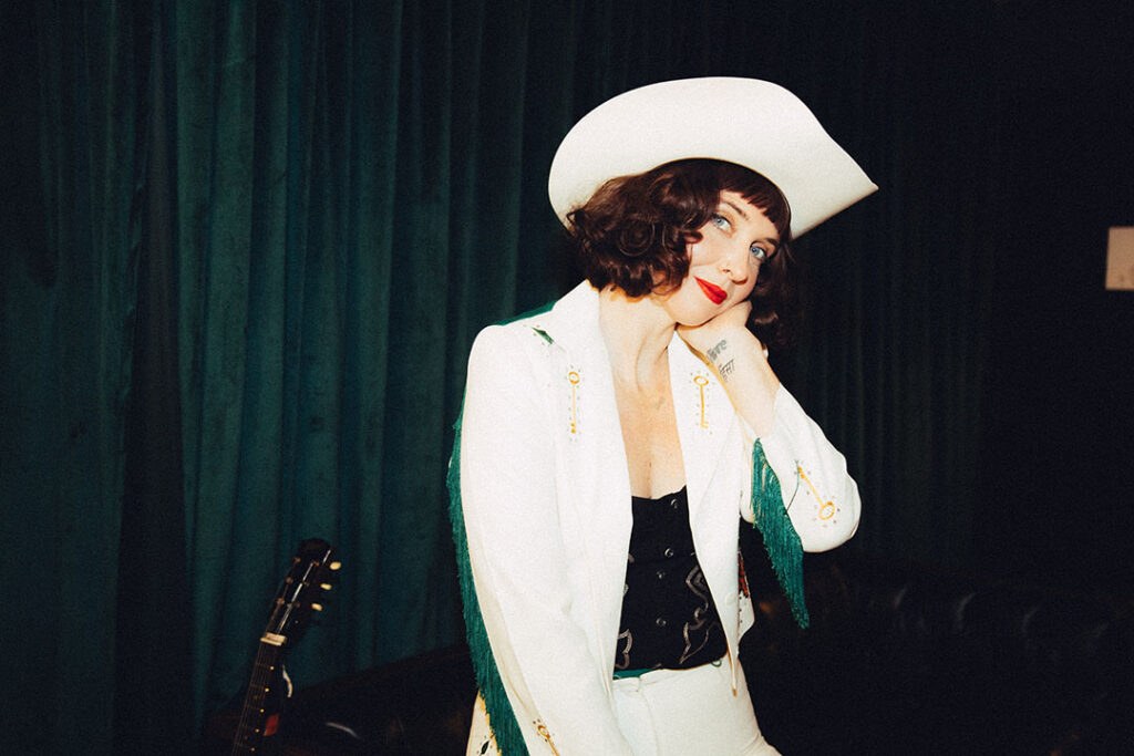 Photo of Sweet Megg in a white outfit and white cowboy hat