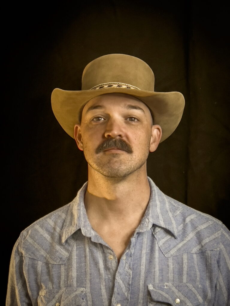 Head shot photo of Doug Andrews wearing a hat