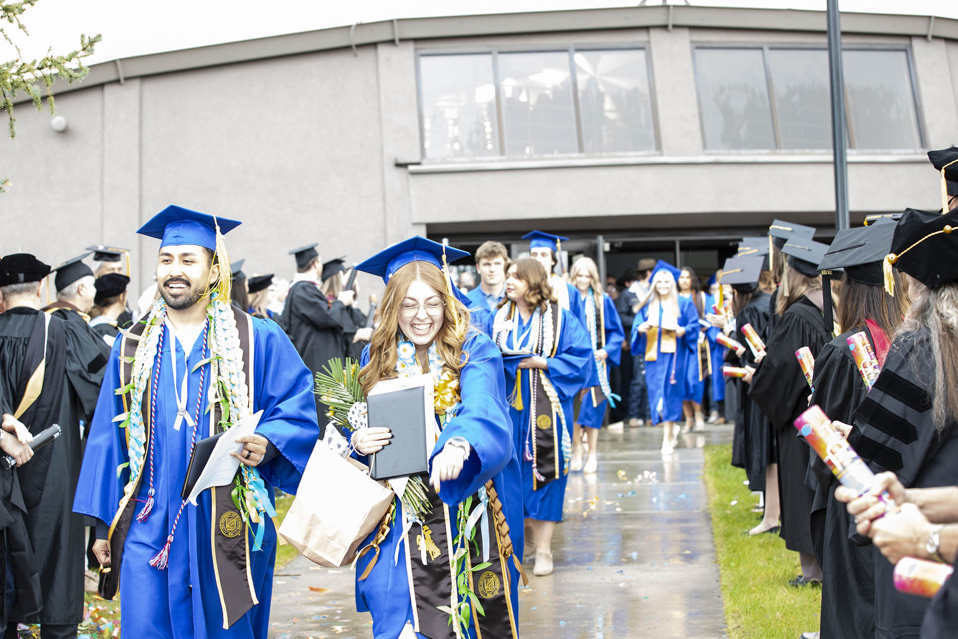 graduates coming out of the dome