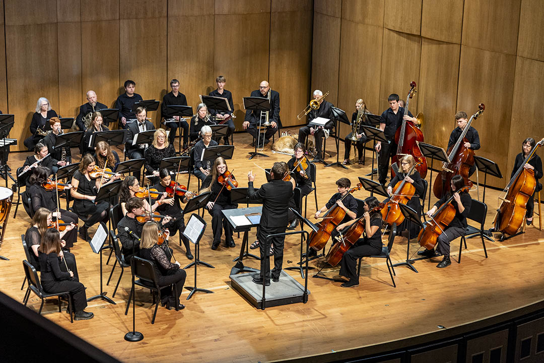 Photo of symphony orchestra on stage in Kinnison Hall from above.
