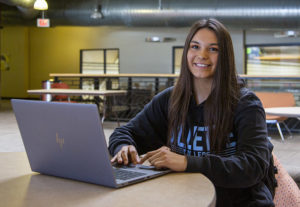 Girl next to her laptop image